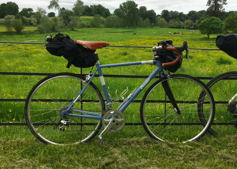 powder blue Condor Fratello road bike against rural estate fencing